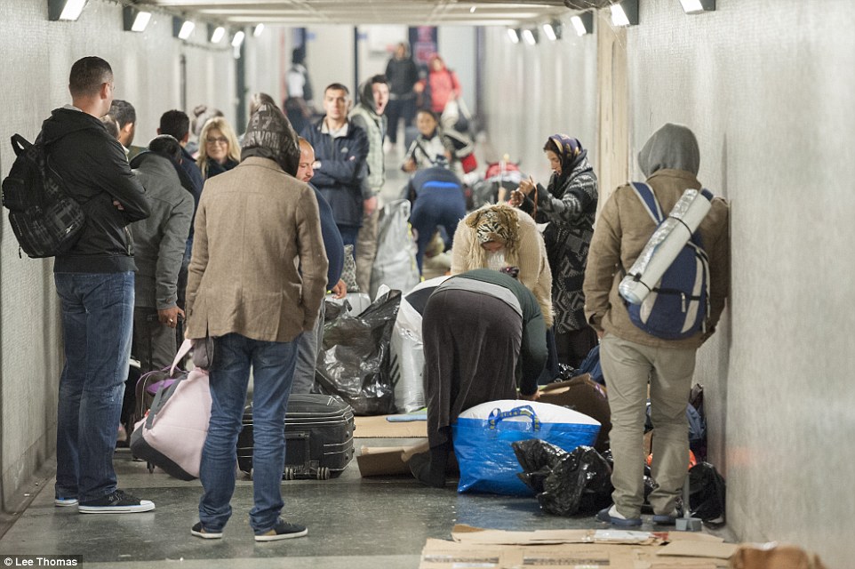 Moving on: Rough sleepers staying in an underpass at Marble Arch pack up their belongings after being approached by immigration officers and police during Operation Encompass this morning
